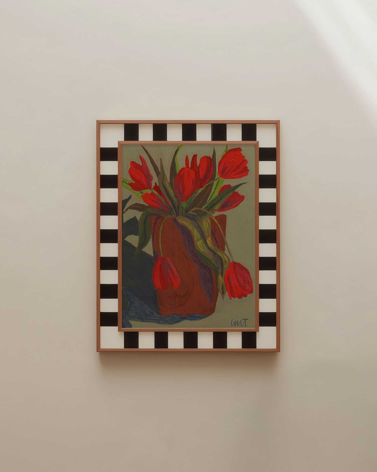 Framed painting of red tulips on a wall with a checkered border